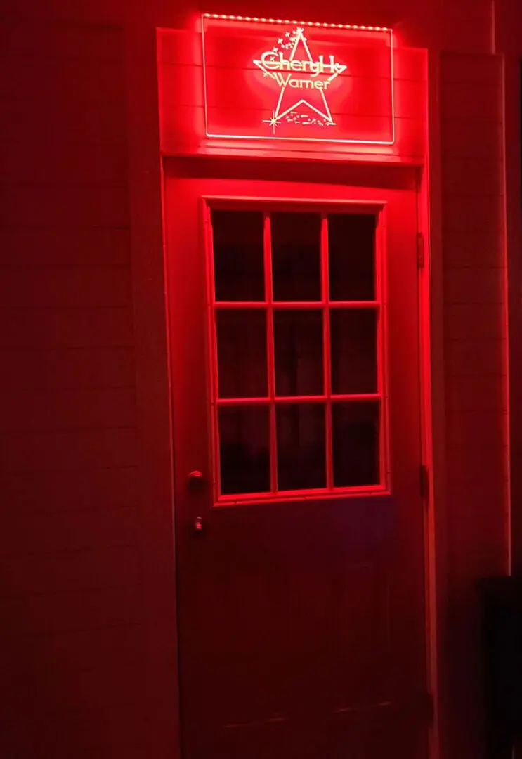 A red lit up door in the dark.