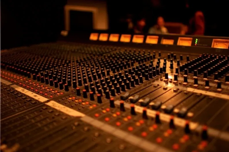 A close up of the sound board in a recording studio